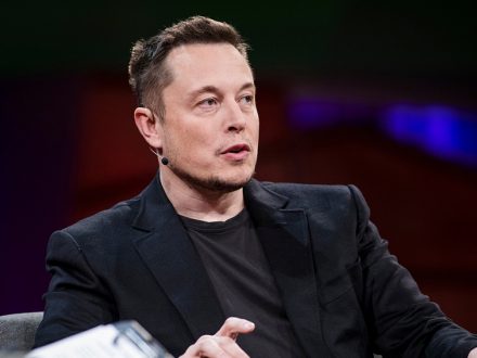 Elon Musk, chatting away, somewhere, dailycarblog.com