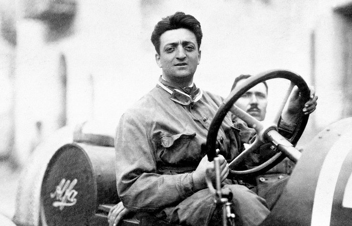 Enzo Ferrari driving and staring