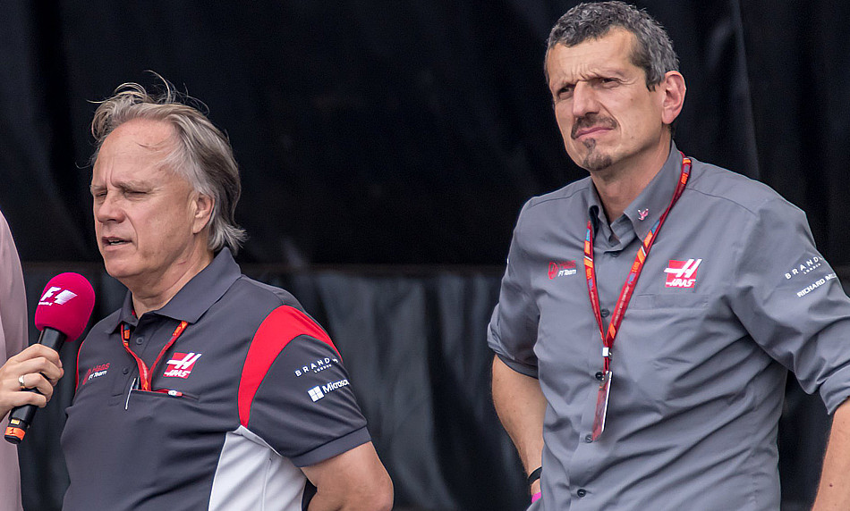Gene Haas with his back to Guenther Steiner