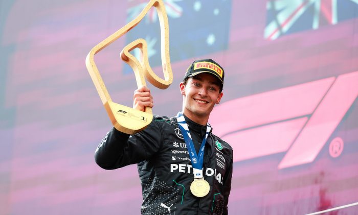George Russell stands on the podium after inheriting victory at the A2024 Austrian Grand Prix